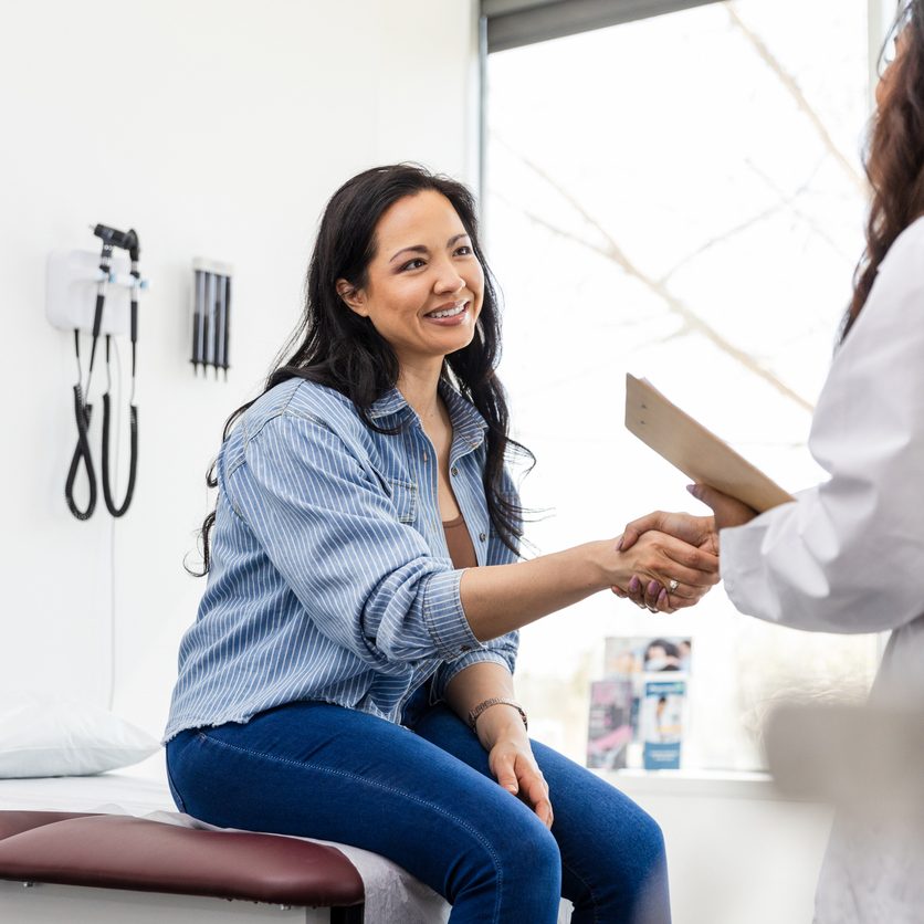 Arriving for her appointment, the unrecognizable female doctor shakes hands with her patient.